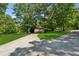 Beautiful home with an inviting entrance, well-manicured lawn, mature trees, and an extended driveway at 4200 E 166 Hwy, Carrollton, GA 30116