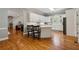 Open kitchen featuring white cabinets, center island, and hardwood floors at 4200 E 166 Hwy, Carrollton, GA 30116