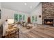 Bright living room featuring a stone fireplace, hardwood floors, and patio access, creating a cozy atmosphere at 4200 E 166 Hwy, Carrollton, GA 30116