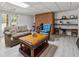 Cozy living room featuring wood burning stove, exposed brick and wood-look floors, creating a rustic and inviting space at 4200 E 166 Hwy, Carrollton, GA 30116