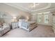 Large main bedroom with tray ceilings, carpet flooring, and access to private patio at 4200 E 166 Hwy, Carrollton, GA 30116