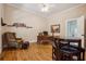 Traditional office with hardwood floors, a large wooden desk, shelving, and a comfortable chair and ottoman at 4200 E 166 Hwy, Carrollton, GA 30116