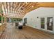 Open porch area with wooden floors, chairs, and a fire pit, ideal for relaxing and enjoying the outdoor scenery at 4200 E 166 Hwy, Carrollton, GA 30116