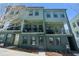 Inviting three-story townhomes featuring black framed windows, balconies, and professionally landscaped front yards at 950 Hughley Cir # 100, Atlanta, GA 30316