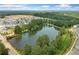 Aerial view of a community with a scenic pond surrounded by trees at 1150 Buice Lake Pkwy, Acworth, GA 30102