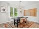 Elegant dining room featuring modern lighting, a dark wood table, and a stylish rug at 1150 Buice Lake Pkwy, Acworth, GA 30102