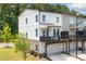 Townhome with a spacious balcony, white siding, and a convenient ground-floor garage at 1150 Buice Lake Pkwy, Acworth, GA 30102