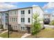 New townhome with brick and siding exterior, lush landscaping, and inviting entrance at 1150 Buice Lake Pkwy, Acworth, GA 30102