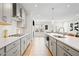 Contemporary kitchen with stainless steel appliances, quartz countertops, and open layout to the living area at 1150 Buice Lake Pkwy, Acworth, GA 30102