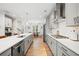Gourmet kitchen showcasing a large island with bar seating, ample storage, and modern lighting fixtures at 1150 Buice Lake Pkwy, Acworth, GA 30102