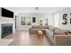 Inviting living room with a cozy fireplace, large windows, and comfortable sectional sofa at 1150 Buice Lake Pkwy, Acworth, GA 30102