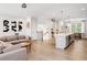 Spacious living room featuring an open floor plan, light wood floors, and modern decor at 1150 Buice Lake Pkwy, Acworth, GA 30102