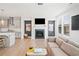 Open concept living room featuring a fireplace, large windows, and access to the kitchen at 1150 Buice Lake Pkwy, Acworth, GA 30102