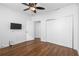 This bedroom features hardwood floors, a ceiling fan, and a closet with sliding doors at 1421 Peachtree Ne St # 310, Atlanta, GA 30309
