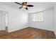 This bedroom has hardwood floors, white walls, and large window with a ceiling fan at 1421 Peachtree Ne St # 310, Atlanta, GA 30309