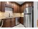 Efficient kitchen with stainless steel appliances, granite countertops, and wood cabinets at 1421 Peachtree Ne St # 310, Atlanta, GA 30309