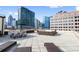 Beautiful rooftop deck featuring lounge seating with city skyline views in the background at 1421 Peachtree Ne St # 310, Atlanta, GA 30309