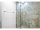 Shower features a glass door, tan tile, and showerhead at 1421 Peachtree Ne St # 310, Atlanta, GA 30309