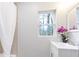 Charming bathroom with a sink, stylish faucet, a mirror, and a window bringing in natural light at 1084 Fairburn Nw Rd, Atlanta, GA 30331