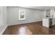 Open-concept living space into kitchen featuring sleek wood floors, natural light, and modern finishes at 1084 Fairburn Nw Rd, Atlanta, GA 30331