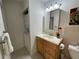 Bathroom featuring a vanity, sink, mirror, stacked washer/dryer, and tiled floor at 5400 Roswell Rd # K1, Atlanta, GA 30342