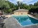 Community pool with sun loungers and ample seating in a lush green setting at 5400 Roswell Rd # K1, Atlanta, GA 30342