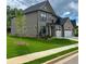View of exterior showcasing well-manicured lawn, mulched flower beds, and craftsman architecture at 4190 Hosch Reserve Dr, Buford, GA 30519