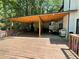 Large, wooden back deck offers versatile outdoor living space and overlooks a treed yard at 1771 Kristi Dr, Lawrenceville, GA 30043