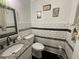 Stylish powder room with granite countertop, modern sink, and subway tile with mosaic accents at 1771 Kristi Dr, Lawrenceville, GA 30043