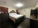 Comfortable bedroom with a large bed, dark hardwood floors, and great natural light at 1771 Kristi Dr, Lawrenceville, GA 30043