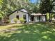 Well-manicured lawn and landscaping complement this home's white exterior and inviting front porch at 1771 Kristi Dr, Lawrenceville, GA 30043
