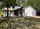 View of the home featuring white siding, black trim, decorative yard accents, and a well-maintained lawn at 1771 Kristi Dr, Lawrenceville, GA 30043