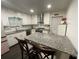 Modern kitchen featuring white cabinets, granite countertops, stainless steel appliances, and a center island with seating at 1771 Kristi Dr, Lawrenceville, GA 30043