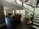 Bright living space featuring hardwood floors, a cozy fireplace, and an open floor plan to the dining area and staircase at 1771 Kristi Dr, Lawrenceville, GA 30043