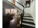 Inviting staircase with black and white risers and wrought iron banister leads to the upper level at 1771 Kristi Dr, Lawrenceville, GA 30043