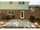 Stone patio featuring a door to a two-story home and a charcoal grill at 1831 Galilee Ct, Tucker, GA 30084