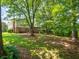 Wide backyard shot featuring large trees and a wide lawn at 1831 Galilee Ct, Tucker, GA 30084
