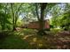 Wide backyard shot featuring large trees and a wide lawn at 1831 Galilee Ct, Tucker, GA 30084