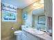 Charming bathroom features decorative paint, updated vanity, and a colorful stained glass window at 1831 Galilee Ct, Tucker, GA 30084