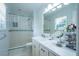 Bright bathroom featuring a shower, sink and vanity with decorative white and green tile at 1831 Galilee Ct, Tucker, GA 30084