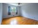Bedroom with hardwood floors and a window letting in natural light at 1831 Galilee Ct, Tucker, GA 30084