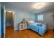 Bright bedroom features hardwood floors, a comfortable bed, and natural light from the window at 1831 Galilee Ct, Tucker, GA 30084