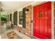 Inviting front porch featuring a bright red door, brick facade, and comfortable seating at 1831 Galilee Ct, Tucker, GA 30084