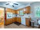 Functional kitchen with light wood cabinets, laminate floors, and essential appliances at 1831 Galilee Ct, Tucker, GA 30084