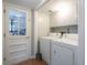 Convenient laundry room featuring a full-size washer and dryer, built-in storage, and lots of natural light at 1831 Galilee Ct, Tucker, GA 30084