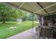 Covered patio and a view of a spacious back yard with a shed, trees and a soccer net at 2194 Freydale Se Rd, Marietta, GA 30067
