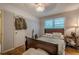 A simple bedroom featuring a wood-frame bed, hardwood floors, and a window at 2194 Freydale Se Rd, Marietta, GA 30067