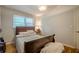 Modest bedroom with hardwood floors, a wood frame bed, and a window with natural light at 2194 Freydale Se Rd, Marietta, GA 30067