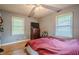 Cozy bedroom featuring hardwood floors, two windows, and a ceiling fan with light fixture at 2194 Freydale Se Rd, Marietta, GA 30067