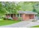 Attractive brick home featuring a well-maintained lawn, charming front steps, and covered side entry at 2194 Freydale Se Rd, Marietta, GA 30067